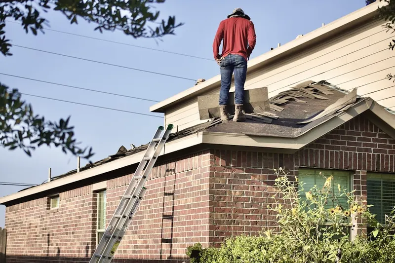 Professional roofer working on a residential roof in Tall PInes
